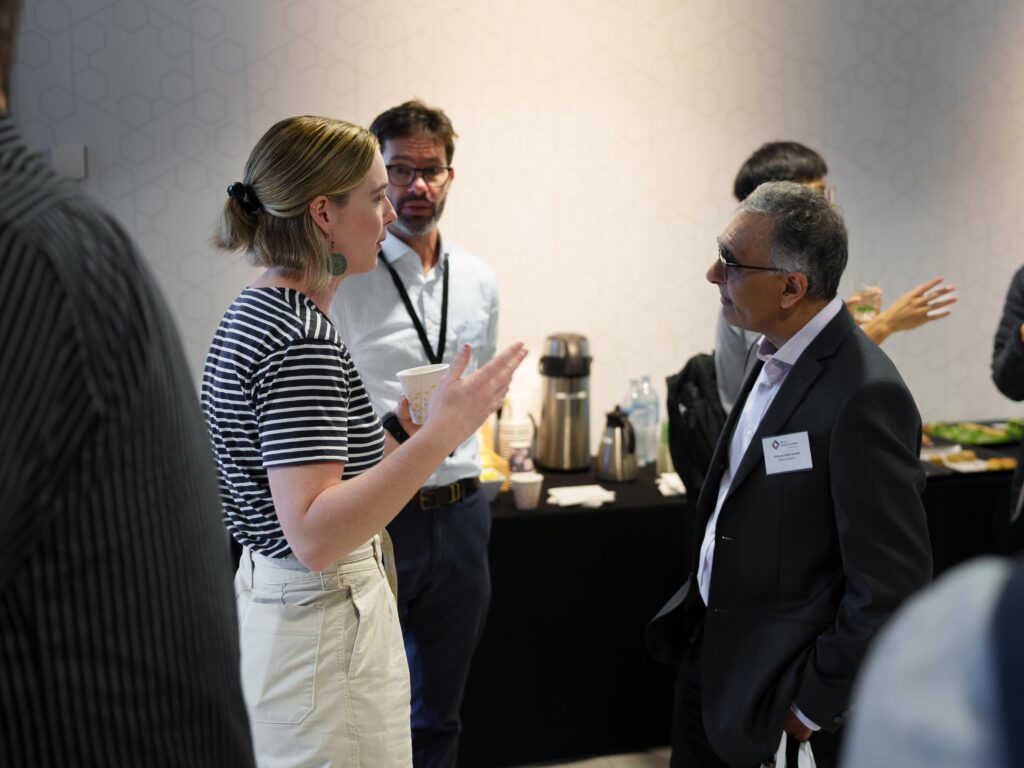 An attendee talks to guest speaker Professor Maher Gandhi at Life as a Clinician-Scientist Queensland 2023.