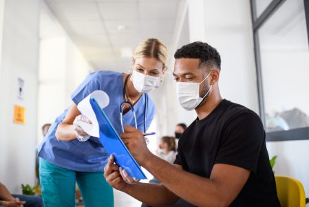AAHMS responds to Treasury's Measuring what matters consultation. image of a nurse and man in face mask in healthcare setting.